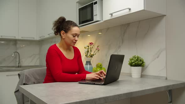 Moving Shot of Beautiful Black Woman Using Laptop Indoors