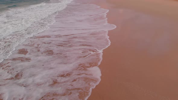 Aerial tilt up shot Empty beach shoreline on Cloudy day, Porto Santo