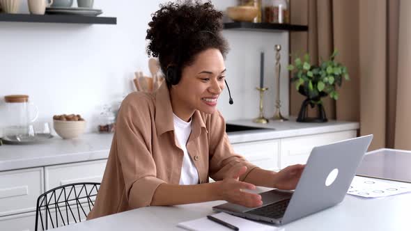 Positive Successful African American Curlyhaired Girl in Casual Clothes Working or Studying From