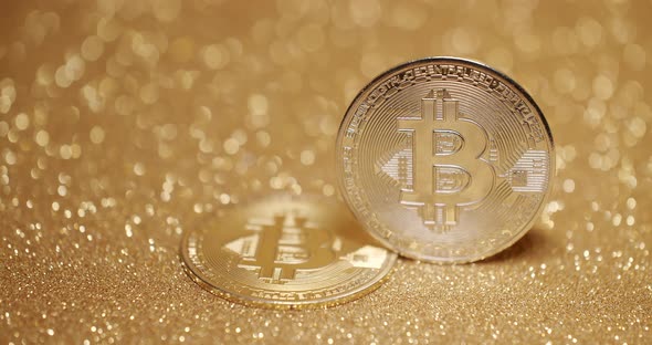 Close Up on gold background with bokeh. Bitcoin BTC coin. New virtual currency.