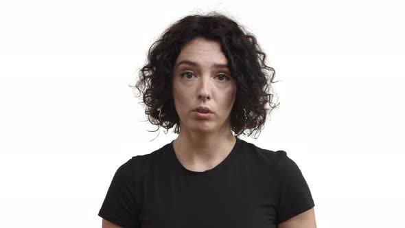 Closeup of Young Attractive Woman with Short Curly Hair Wearing Black Tshirt Saying No to Someone