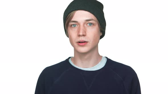 Portrait of Blueeyed Teenager in Hat with Clean Skin Being Surprised Shocked with Opened Mouth Over