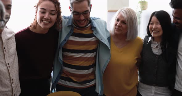 Happy multiracial friends having fun together at home kitchen