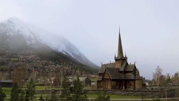 Lom Stave Church (Lom Stavkyrkje) In The Scenic Norwegian Countryside During Autumn - aerial drone s