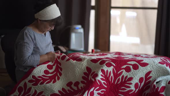 Woman making a Hawaiian quilt