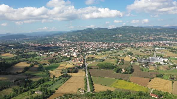 Aerial view of a town, green hills and countryside in Italy