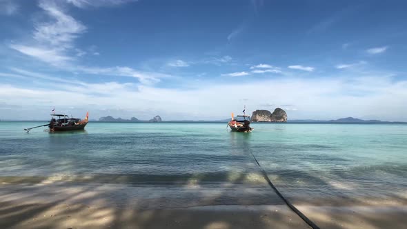 Long-tail boats close to the beach of Koh Ngai 