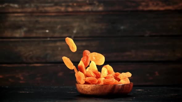 Dried Apricots Fall with a Wooden Plate and Rotate in Flight