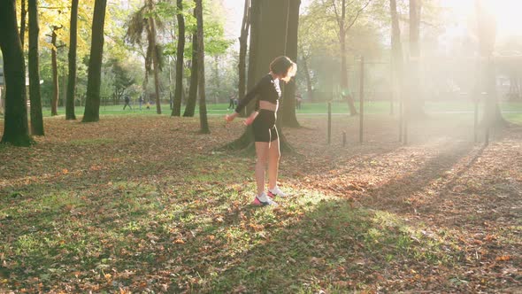 Woman in Sport Clothing Squatting on Fresh Air