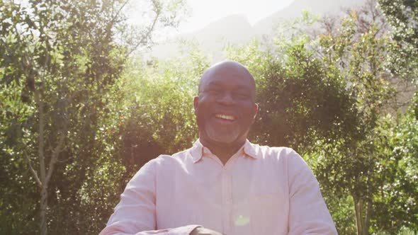 Happy african american senior man looking at camera outdoors