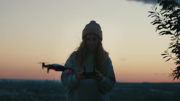 Young Casual Woman Using Aerial Drone to Take Pics