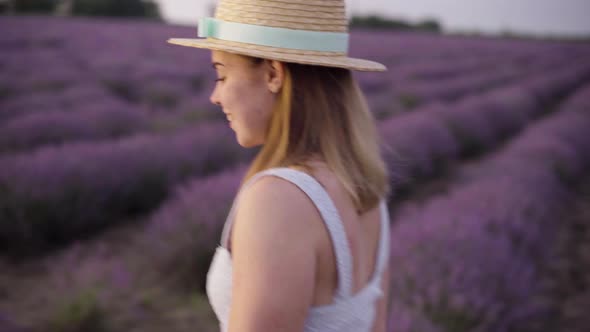 Close Up of a Beautiful Smiling Girl in a Hat on a Lavender Field