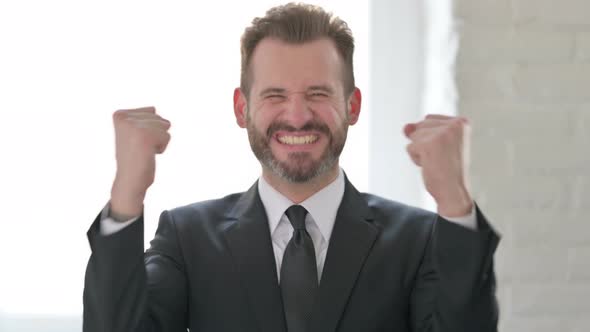 Excited Middle Aged Businessman Celebrating Success