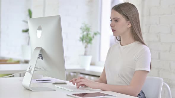 Hardworking Young Woman Having Failure on Desktop 