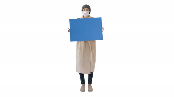 Woman in Outdoor Clothes and in Medical Mask Holding Blank Board on White Background