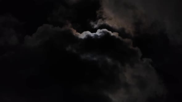 Full Moon Moving Between Clouds