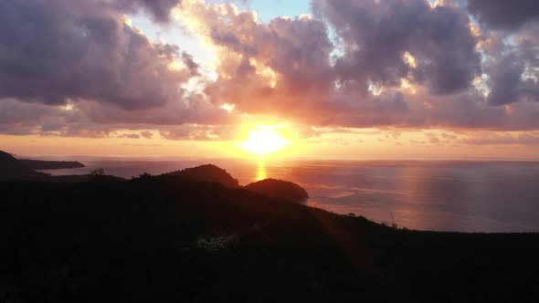 Orange Colored Sunshine Reflecting On The Sea Along WIth The Islands In Fiji. -wide shot