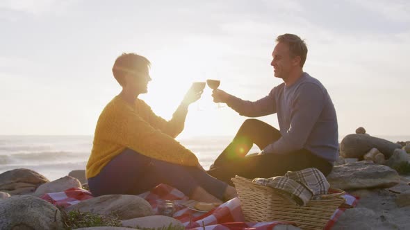 Couple drinking wine by the sea