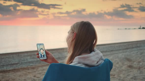 Woman Making Video Call with Smartphone on the Seashore