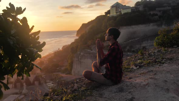 Silhouette of a Man Praying at Sunset Concept of Religion