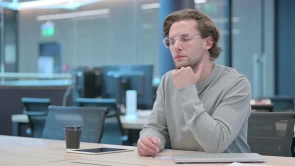 Young Businessman Taking Nap in Office