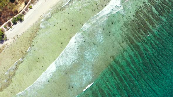 Aerial view travel of relaxing shore beach trip by clear water with white sandy background of a picn