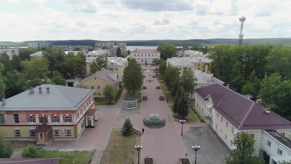 People walks along a beautiful alley in a provincial town. Aerial 04