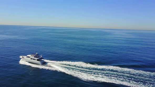 Aerial drone uav view of a motor boat and the ocean.