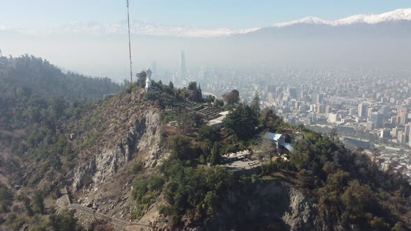 Aerial view of Santiago de Chile inside a fog from the Cerro San Cristobal. Blue Sky, Green Parks an