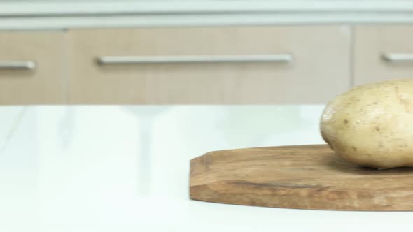 Panning Shot of Potato on Chopping Board