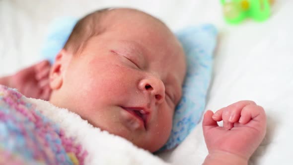 Little Newborn Baby Six Days Age Lies On A Crib In Diapers