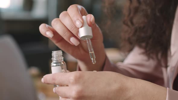 Woman Applying Serum On Skin