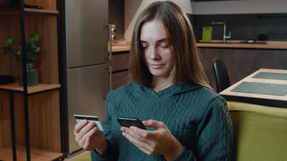 Young Woman Shopping Online on Sofa at Home. Smiling Woman Online Banking Using Smartphone Shopping