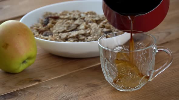 Pouring Coffee Into a Cup with Turks for Breakfast with Oatmeal in Slow Mo