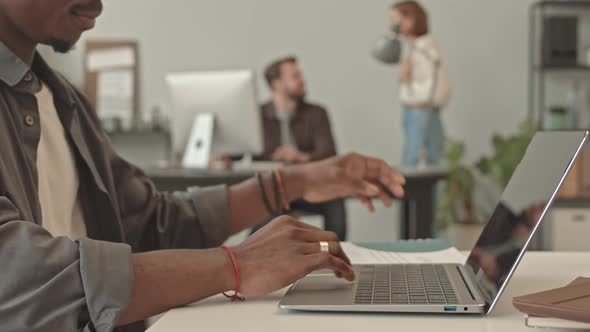 Man Working with Papers and Computer