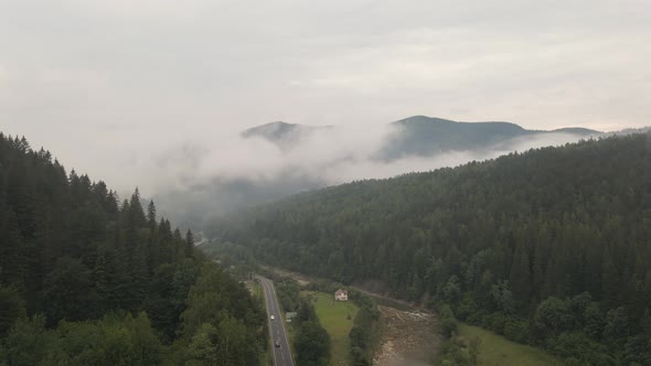 Beautiful winding road going through an amazing mist covered valley