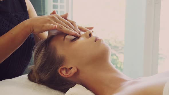 Woman Gets Facial and Head Massage in Luxury Spa