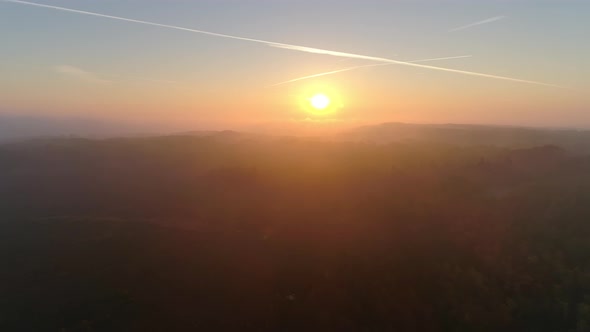 Aerial View of Sunrise Over Foggy Landscape