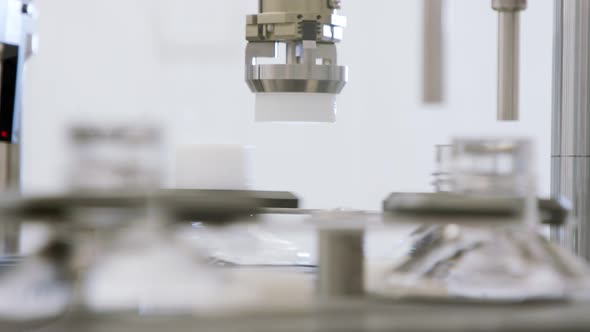 Automated pharmaceutical manufacturing line, bottles filled with liquid