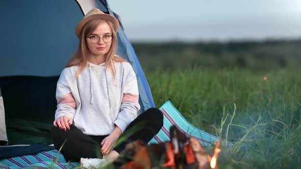 Trendy Girl Sit Near Camping Tent Relaxing Outdoor at Sunset