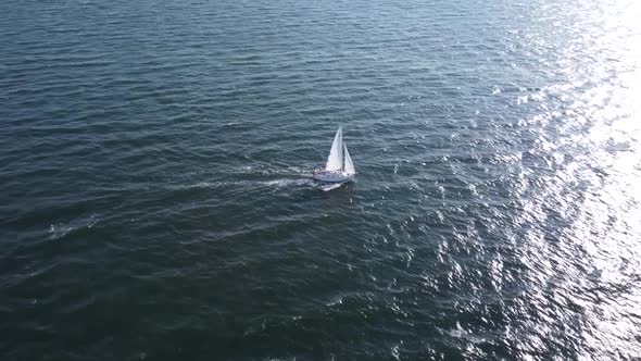 Sailboat Sailing in seawater by coastline in Massachusetts