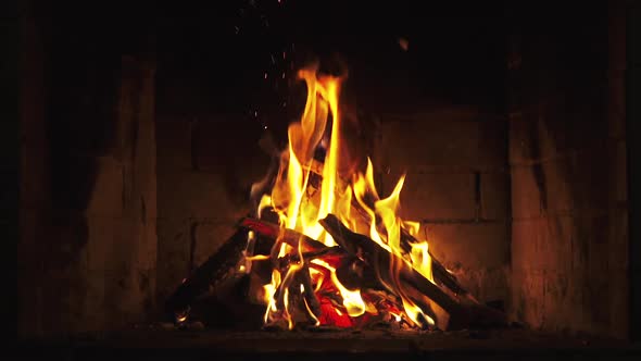 A Looping Clip of a Fireplace with Medium Size Flames Burning Fire Slow Motion. 