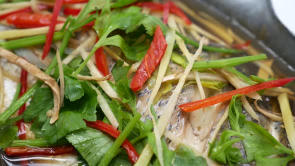 Close-up Footage of Steamed Sea Bass in Soy Sauce Soup, Chinese-Thai Popular Dish, The Combination o