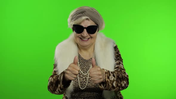 Old Style Granny Caucasian Woman Puts on Sunglasses. Chroma Key Background