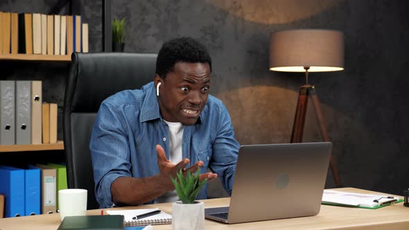 Excited African American Man Looks at Laptop Celebrates Financial Market Growth