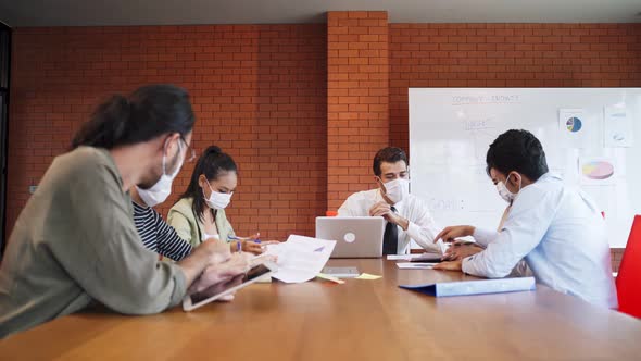 Group of Asian team business people working in office with new normal lifestyle in meeting room.