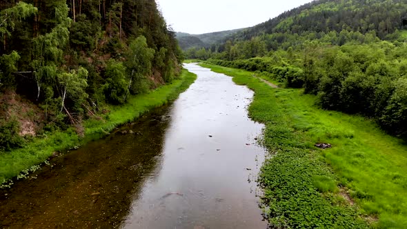 A river among rocks and trees.