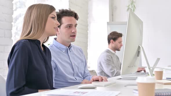 Cheerful Creative Team Doing Video Chat on Desktop