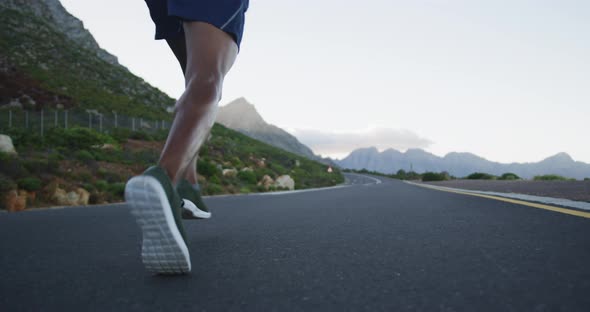 Rear view of african american man running on the road