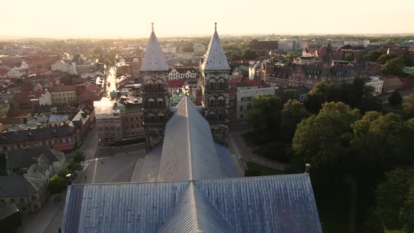 Drone flying fast over Lund Cathedral, Golden hour, Sweden